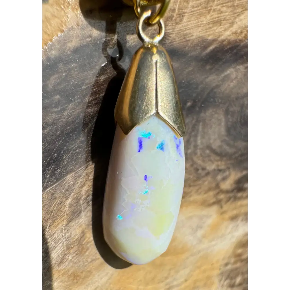 Opal pendant with gold cap from Golden Horizons featuring a Lightning Ridge white opal