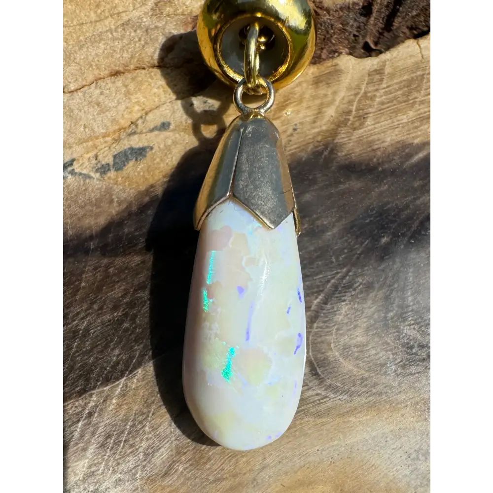 Teardrop-shaped Lightning Ridge White Opal pendant with gold accents from Golden Horizons