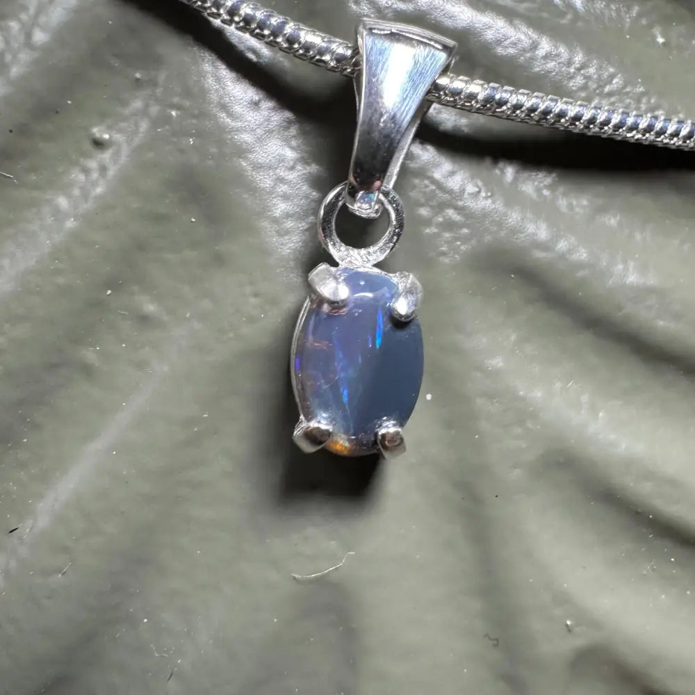 Silver opal pendant necklace featuring a handcrafted 0.6ct Lightning Ridge Opal in sterling silver