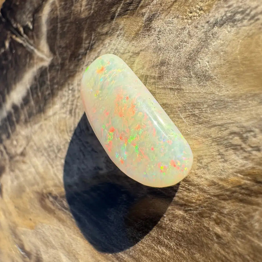 Iridescent Coober Pedy opal cabochon in a 2.9-carat hand-cut solid gemstone display