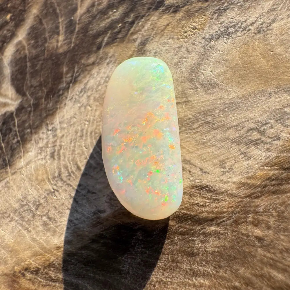 Iridescent Coober Pedy opal cabochon in a hand-cut 2.9 carats showcasing vibrant colors