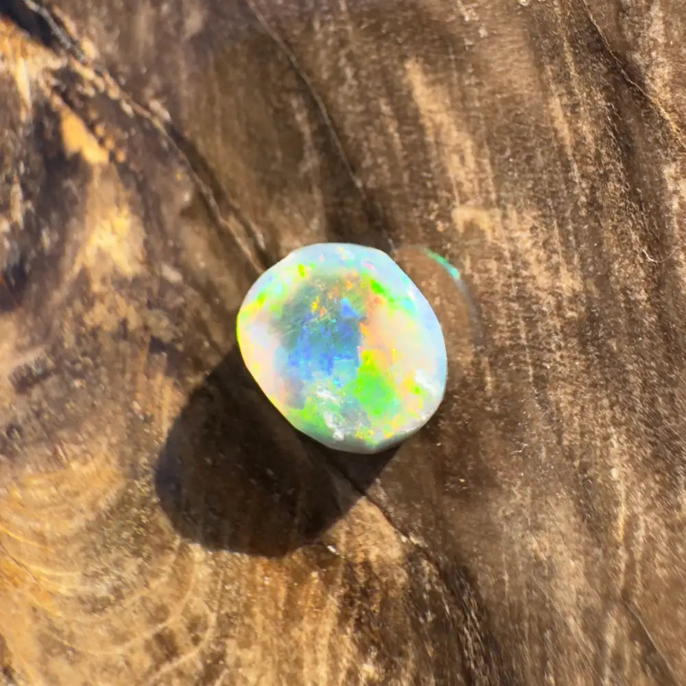 Iridescent opal gemstone displayed in a Hand-Cut Solid Lightning Ridge Black Opal 0.9 carat