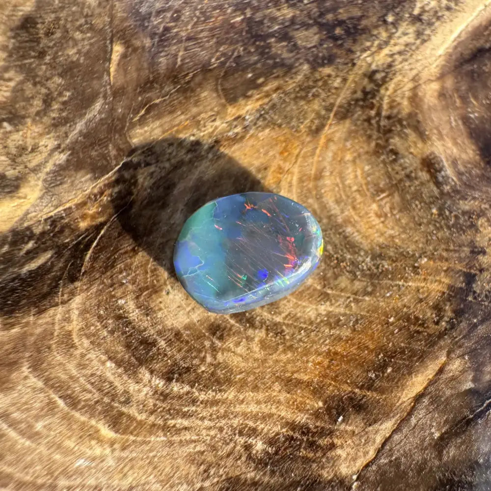 Iridescent Lightning Ridge Black Opal gemstone in a handcrafted 0.9carat product