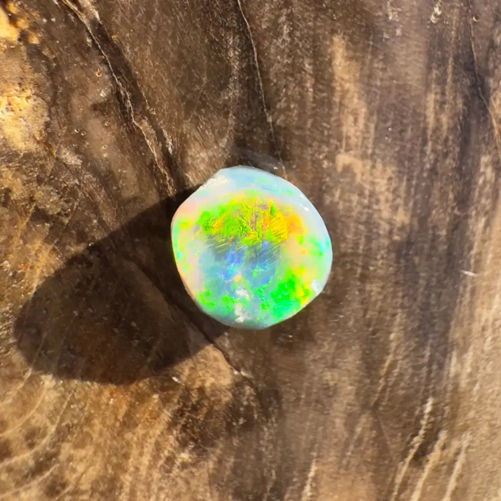 Iridescent Opal gemstone displayed in the Hand-Cut Solid Lightning Ridge Black Opal 0.9 Carat product