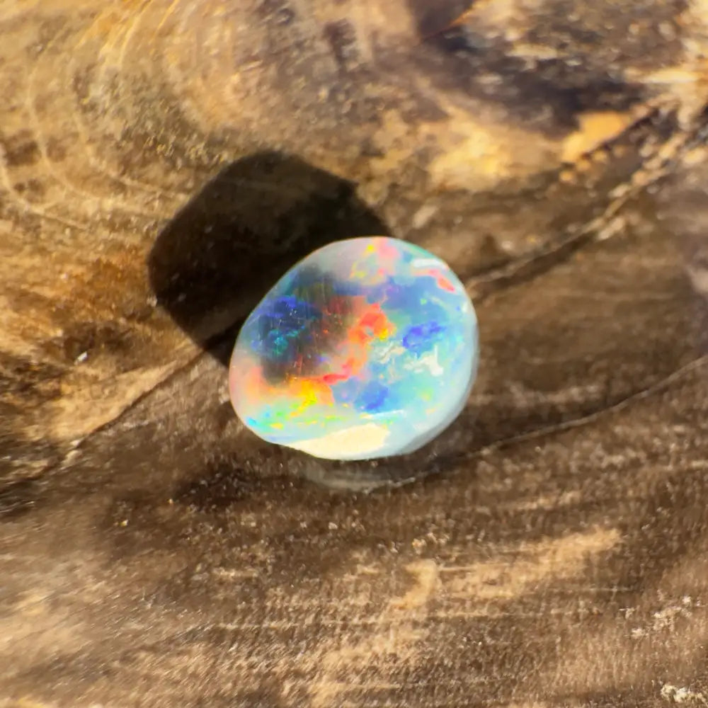 Iridescent Lightning Ridge Black Opal gemstone in a hand-cut 0.9 carat product