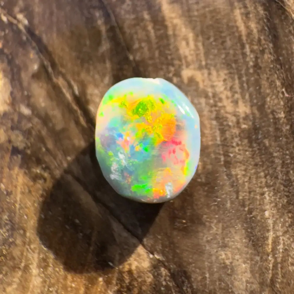 Iridescent opal gemstone displayed in a Hand-Cut Solid Lightning Ridge Black Opal 0.9carat