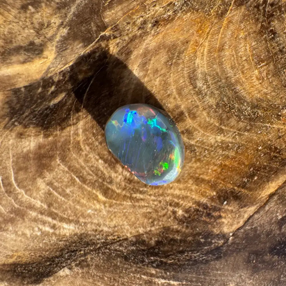 Iridescent black opal gemstone from Lightning Ridge in a 0.9carat hand-cut form