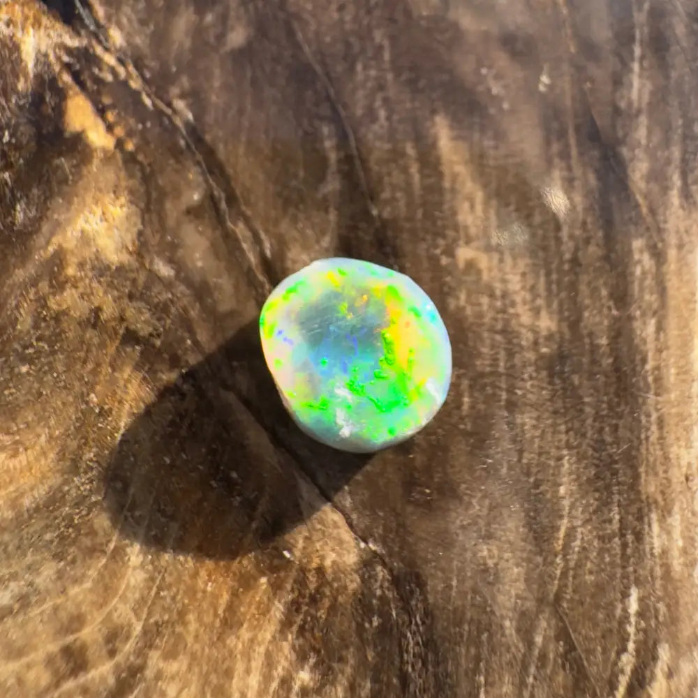 Hand-cut Solid Lightning Ridge Black Opal with iridescent rainbow hues 0.9 carats