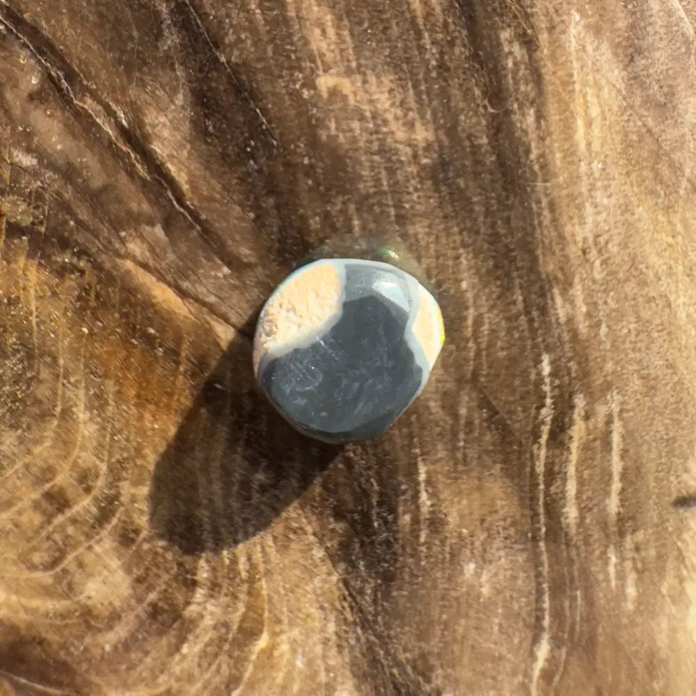 Polished blue and white stone details in Hand-Cut Solid Lightning Ridge Black Opal 0.9carat