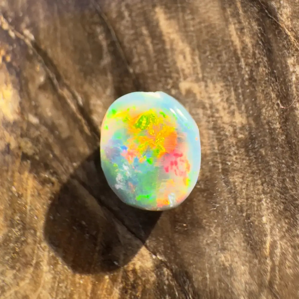 Iridescent Lightning Ridge Black Opal gemstone in a hand-cut 0.9 carat form