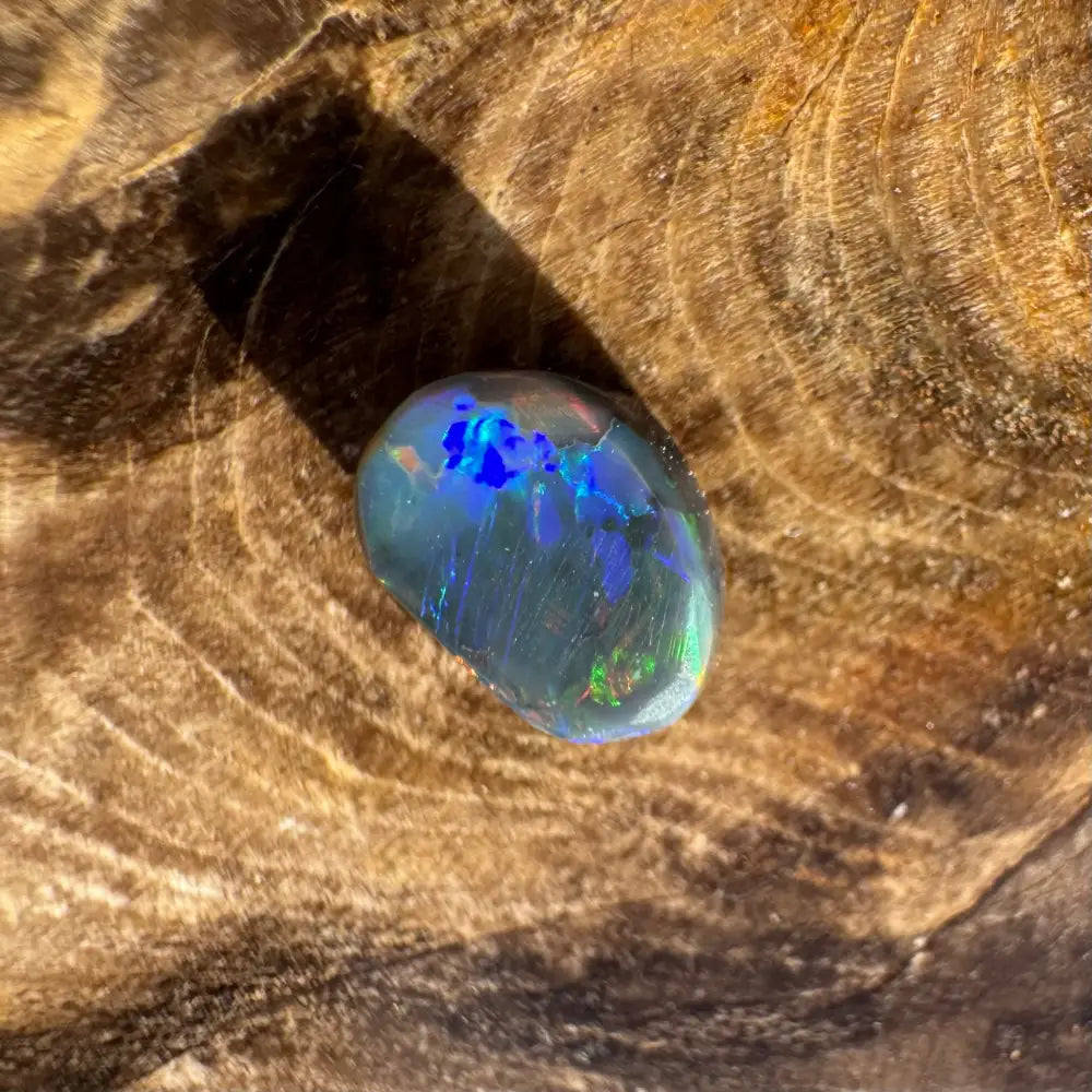 Iridescent opal gemstone from Hand-Cut Solid Lightning Ridge Black Opal 0.9carat product