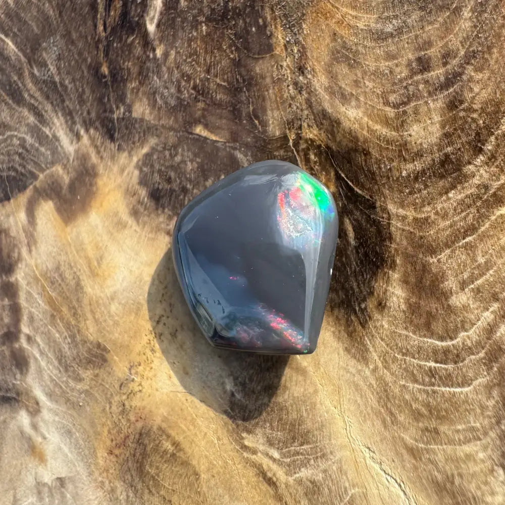 Polished black opal with iridescent flashes in the Hand-Cut Solid Lightning Ridge Black Opal 4.0carat