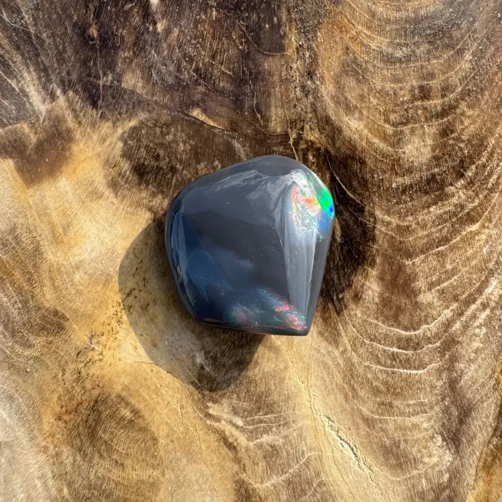 Polished Lightning Ridge Black Opal with iridescent flashes in a 4.0-carat hand-cut setting