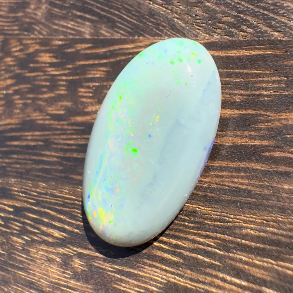 Oval Opal gemstone with iridescent color play in a Hand-Cut Solid Lightning Ridge Opal 11.6carat
