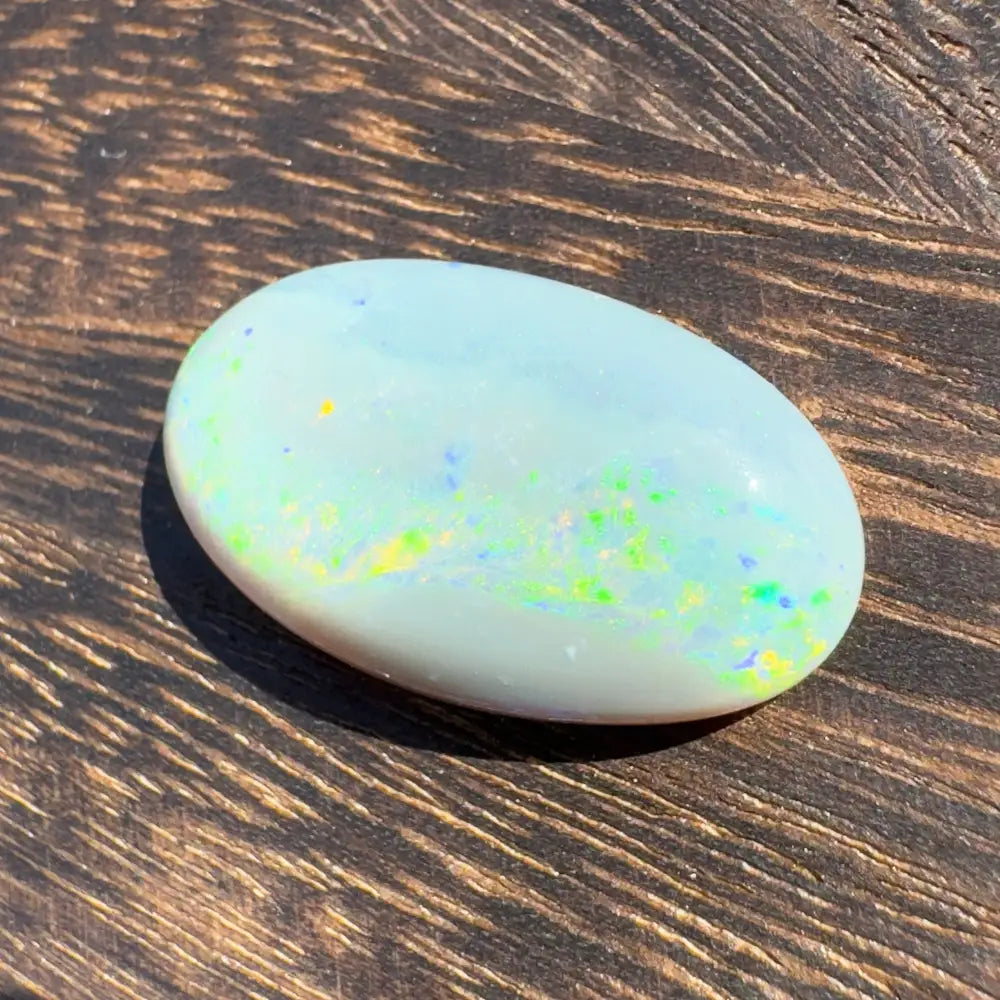 Oval opal gemstone with vibrant colorful flashes in a Hand-Cut Solid Lightning Ridge Opal 11.6 carats