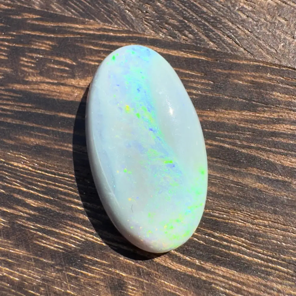 Oval Opal gemstone displaying iridescent colors in the Hand-Cut Solid Lightning Ridge Opal 11.6carat