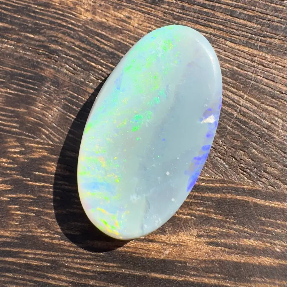 Oval opal with iridescent colors in the Hand-Cut Solid Lightning Ridge Opal 11.6 carats