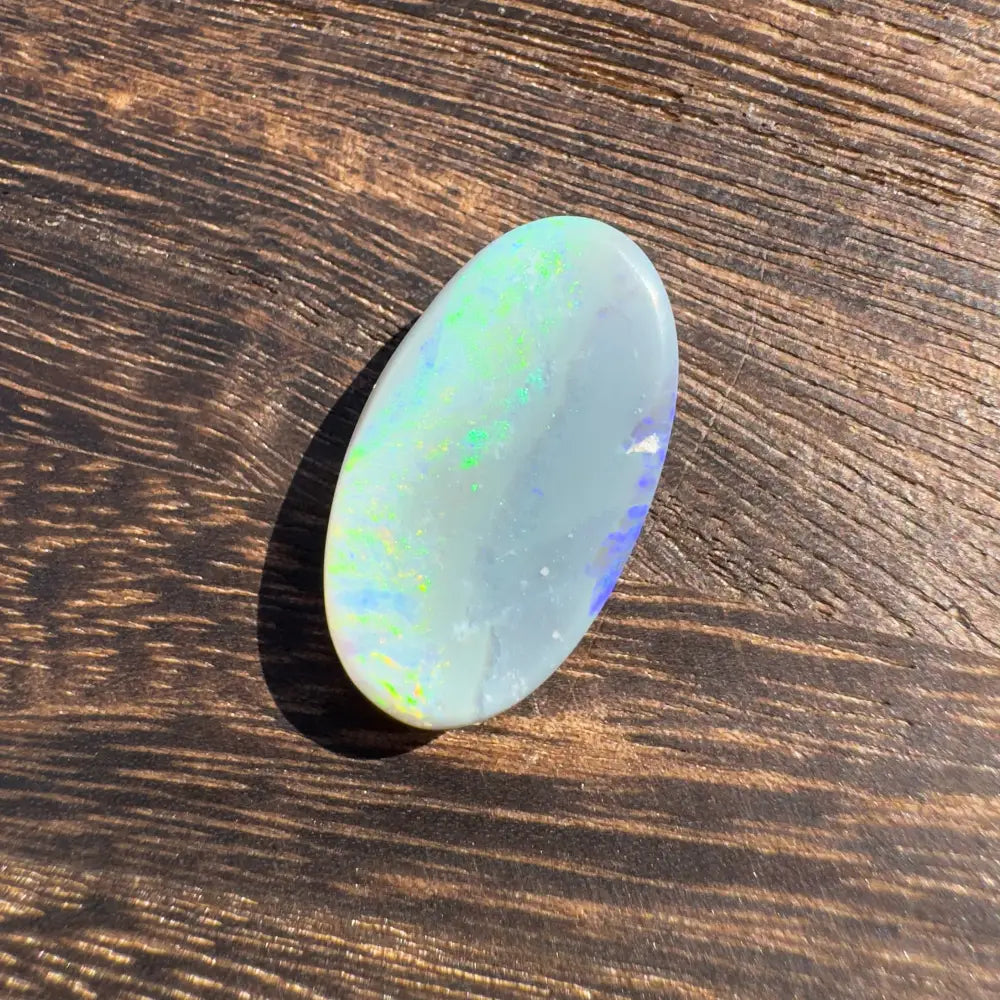 Iridescent oval Opal cabochon from Lightning Ridge in a 11.6 carat hand-cut opal display