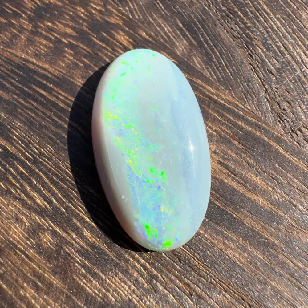 Oval Lightning Ridge Opal with green and blue iridescence displaying vibrant colors
