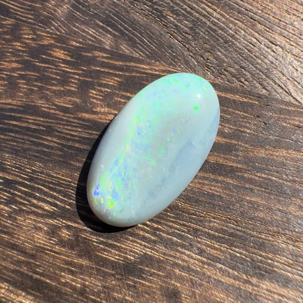 Polished Lightning Ridge Opal with iridescent play-of-color in a hand-cut solid gemstone