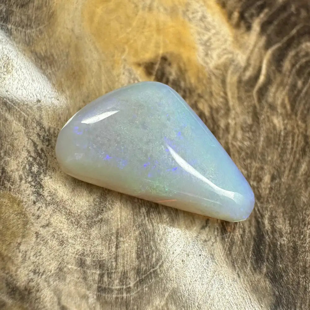 Polished iridescent Lightning Ridge Opal gemstone in a hand-cut 4.1 carat specimen