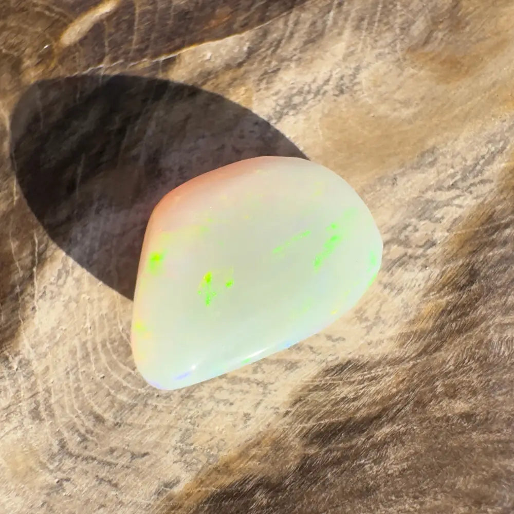 Iridescent Lightning Ridge opal gemstone in a 4.1 carat hand-cut solid gemstone display