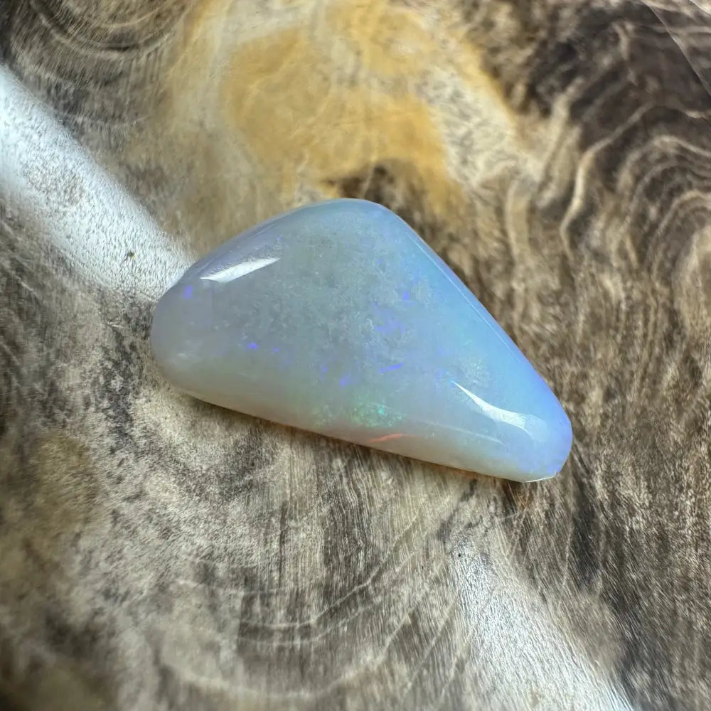 Iridescent polished opal cabochon from Lightning Ridge in a 4.1-carat hand-cut solid specimen