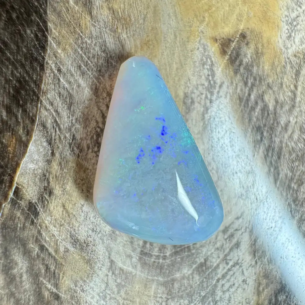Iridescent triangular Lightning Ridge Opal gemstone in a handcrafted jewelry piece