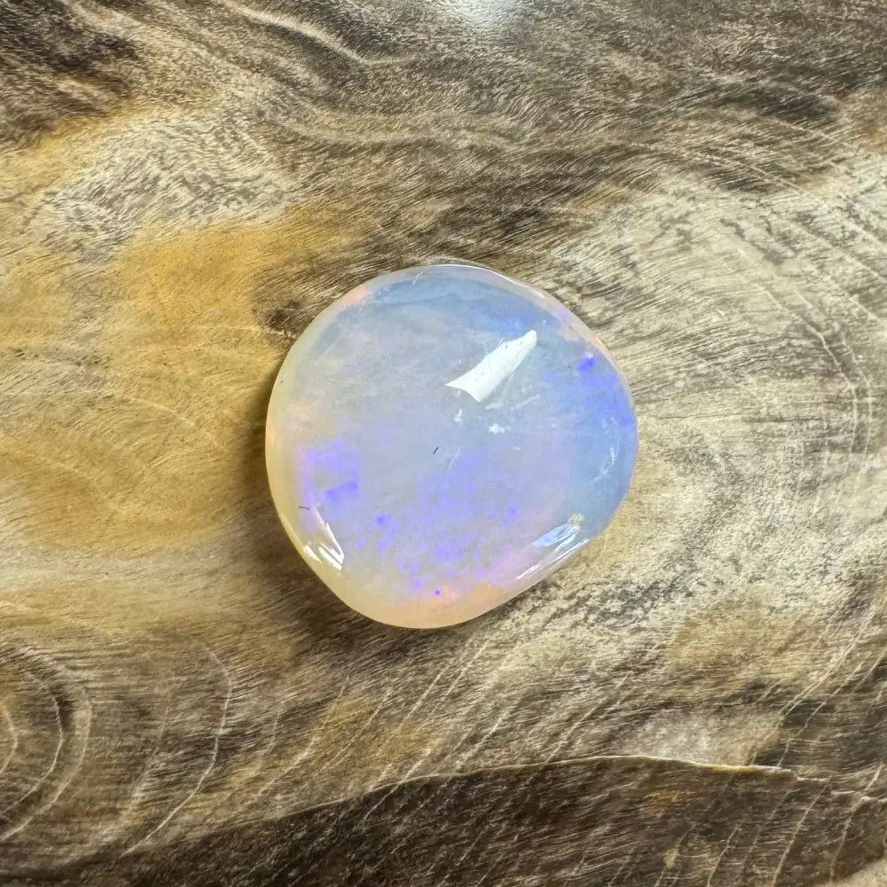 Hand-cut Solid Lightning Ridge Opal 4.7 carats showcasing translucent blue and orange iridescence