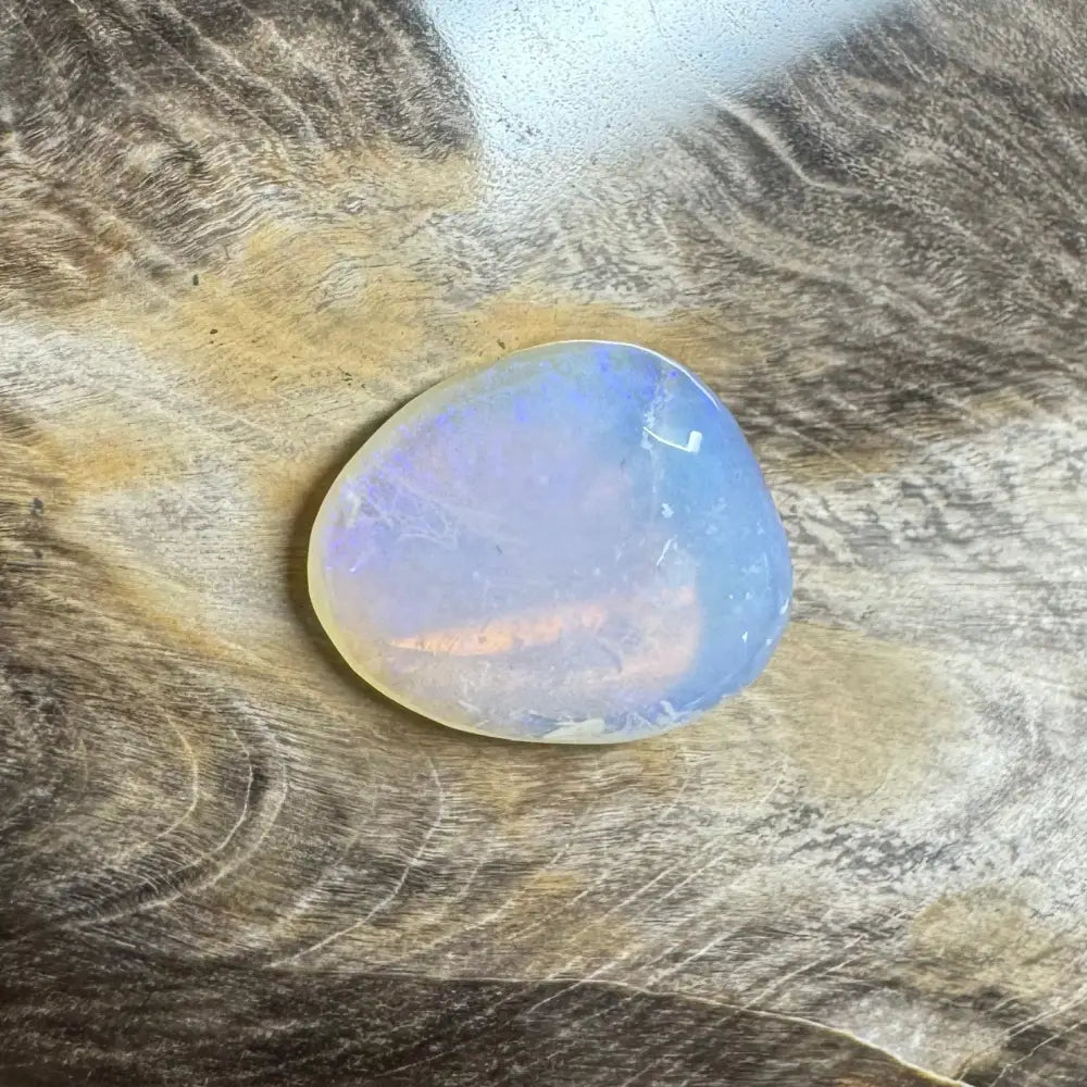 Iridesscent translucent polished Lightning Ridge Opal gemstone valued at 4.7 carats