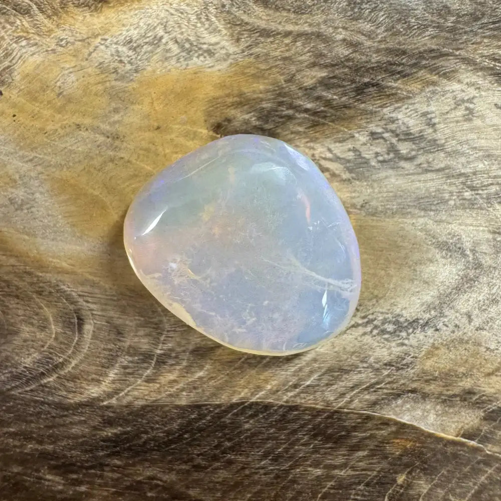 Translucent polished opalite stone displayed with Hand-Cut Solid Lightning Ridge Opal 4.7carat