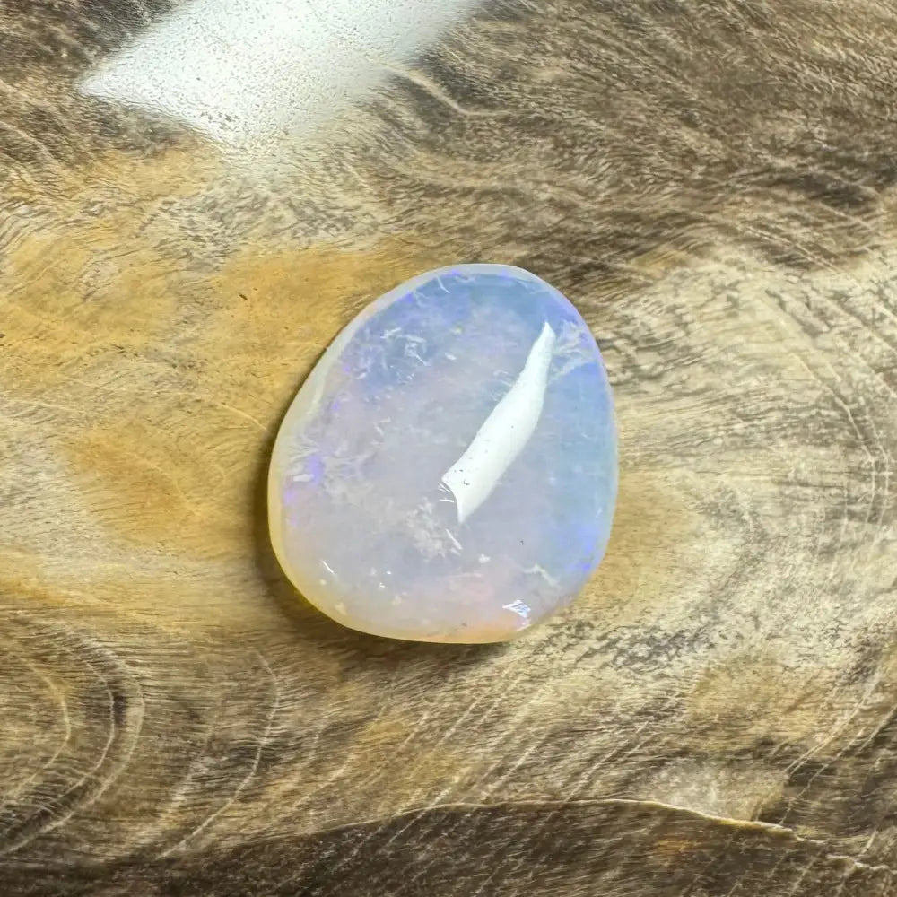 Iridescent polished Lightning Ridge opal stone in a hand-cut 4.7 carat jewelry piece