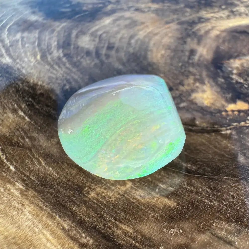 Iridescent rounded lightning ridge opal gemstone for jewelry or collection purposes