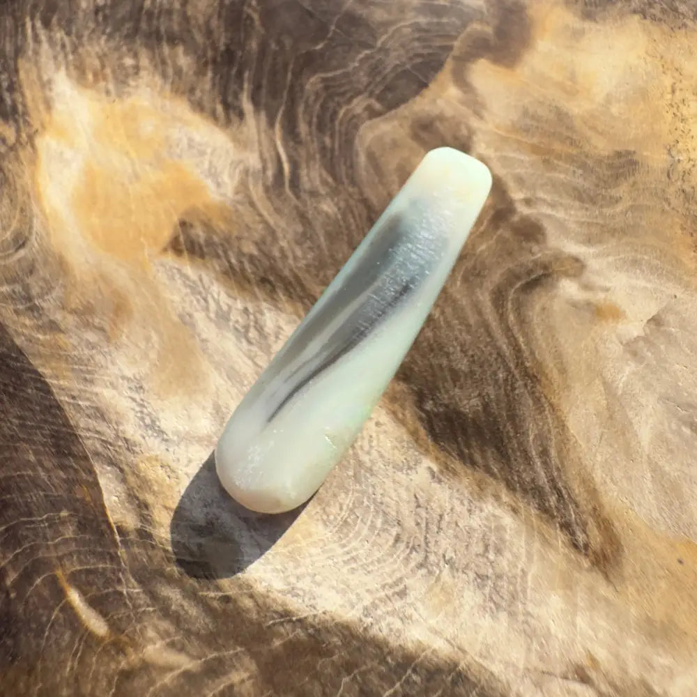 Smooth pale green stone with dark gray streaks in Hand-Cut Solid Lightning Ridge Opal 7.5 carats