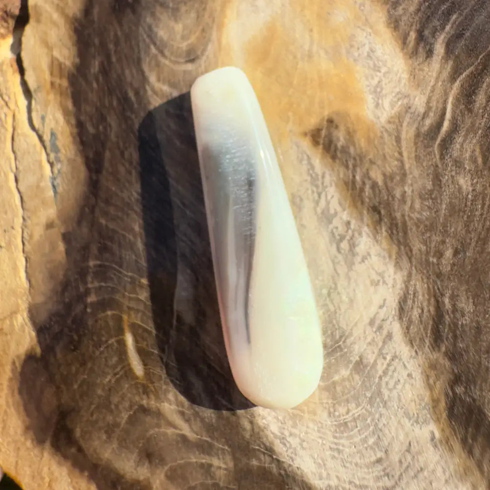 Smooth white and gray teardrop-shaped Lightning Ridge Opal gemstone for jewelry