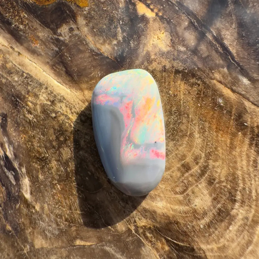 Polished Lightning Ridge semi-black opal with iridescent colors in a 2.8 carat handcrafted setting