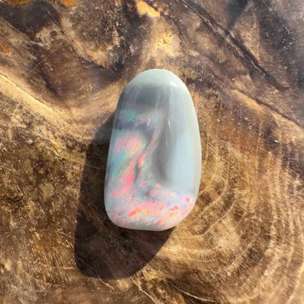 Polished Lightning Ridge semi black opal cabochon with vibrant iridescent play-of-color