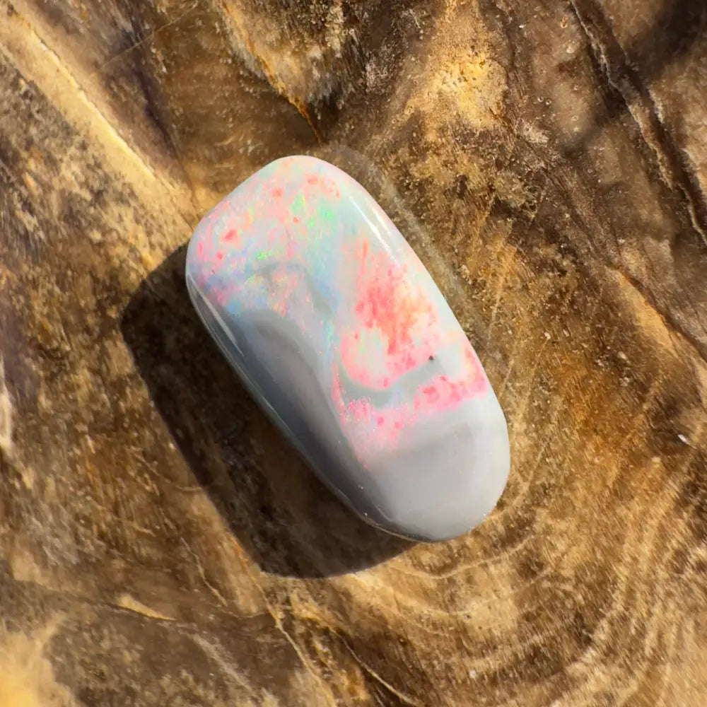 Polished Lightning Ridge semi black opal with pink and blue iridescence, 2.8 carats