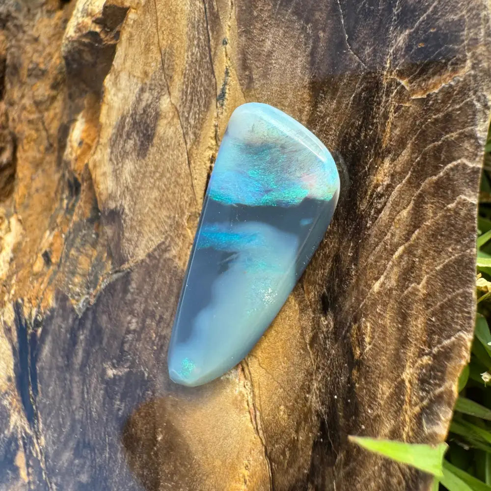 Iridescent blue and gray polished Lightning Ridge semi black opal gemstone