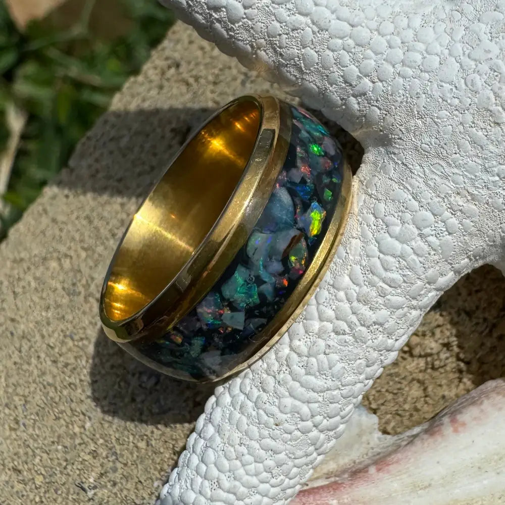 Gold ring with Australian opal inlay in surgical steel size L (6) displayed