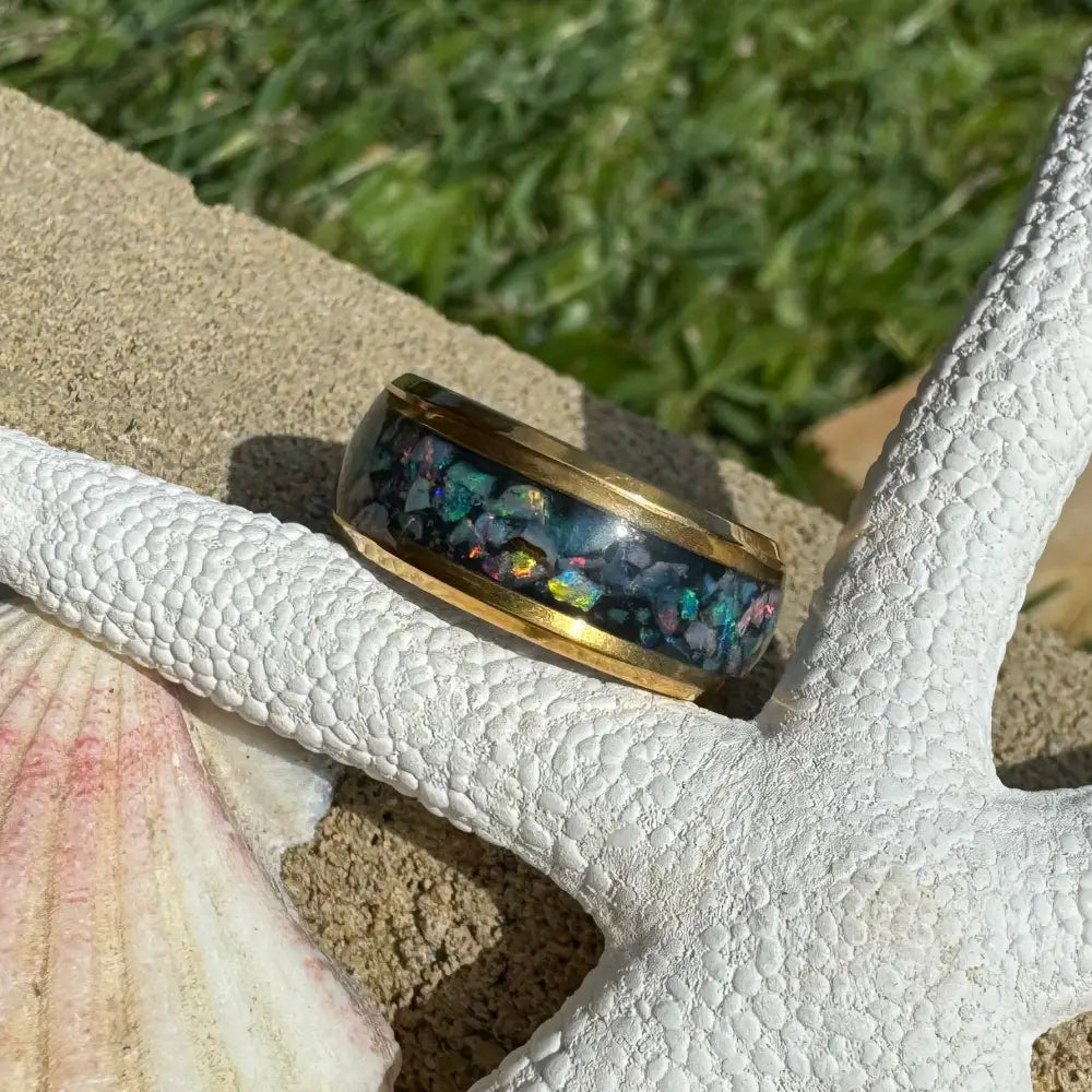 Gold-banded ring with Australian opal inlay in a handcrafted design on surgical steel base