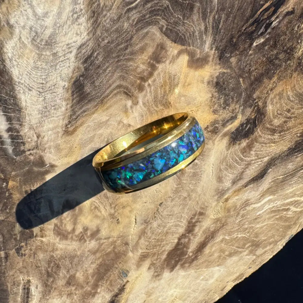 Gold ring with blue opal inlay from Handcrafted Australian Opal Ring Gold Surgical Steel Size X 1/2