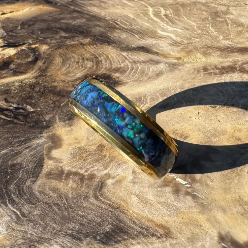 Gold ring with vibrant blue opal inlay in handcrafted Australian jewelry piece