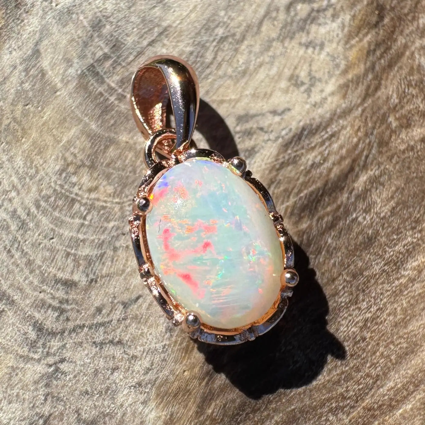 Oval opal pendant with rose gold setting in the Larapinta Flame handcrafted jewelry collection