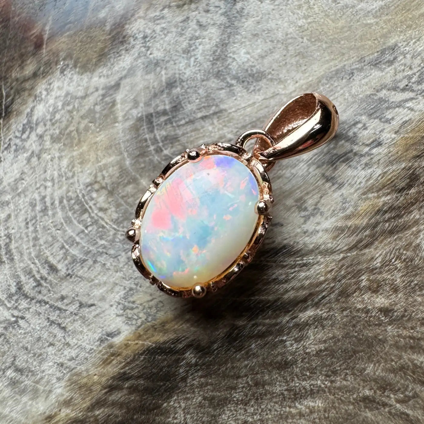 Oval Coober Pedy Opal pendant with rose gold setting in the Larapinta Flame collection