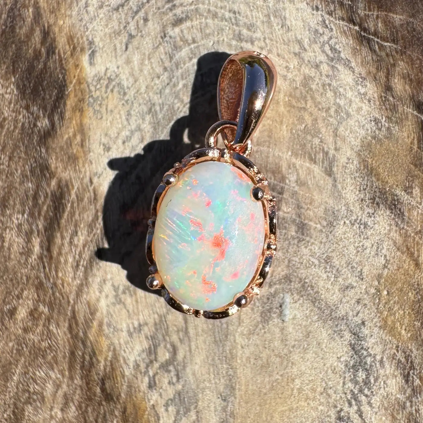 Oval Coober Pedy Opal pendant with rose gold setting on sterling silver chain