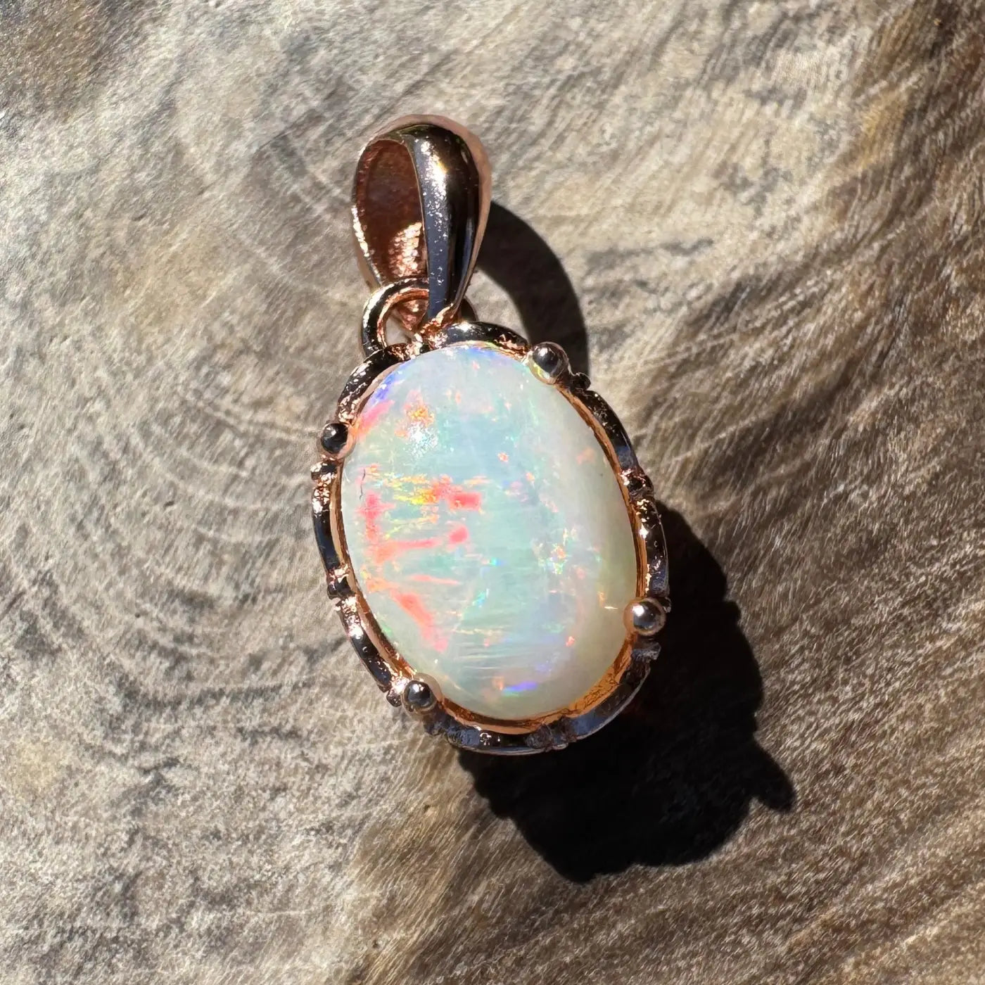 Oval opal pendant with rose gold setting from Larapinta Flame handcrafted sterling silver accessory