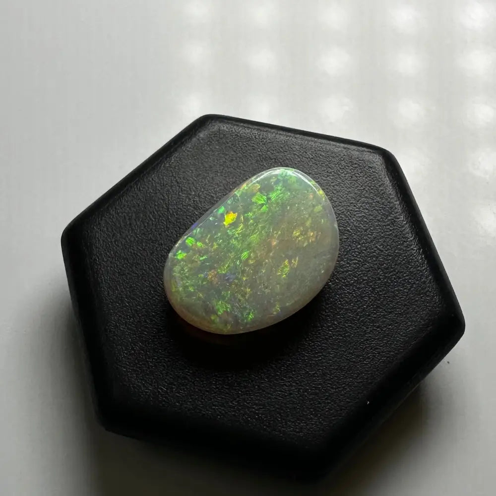 Iridescent Lightning Ridge Opal gemstone displayed in the 2.4 carat solid hand-cut product