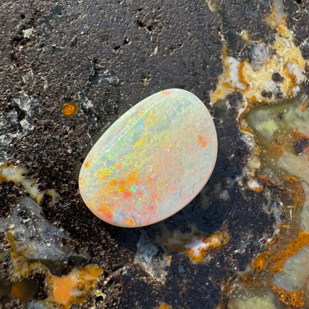 Iridescent Lightning Ridge Opal gemstone in a 2.4 carat solid hand-cut display