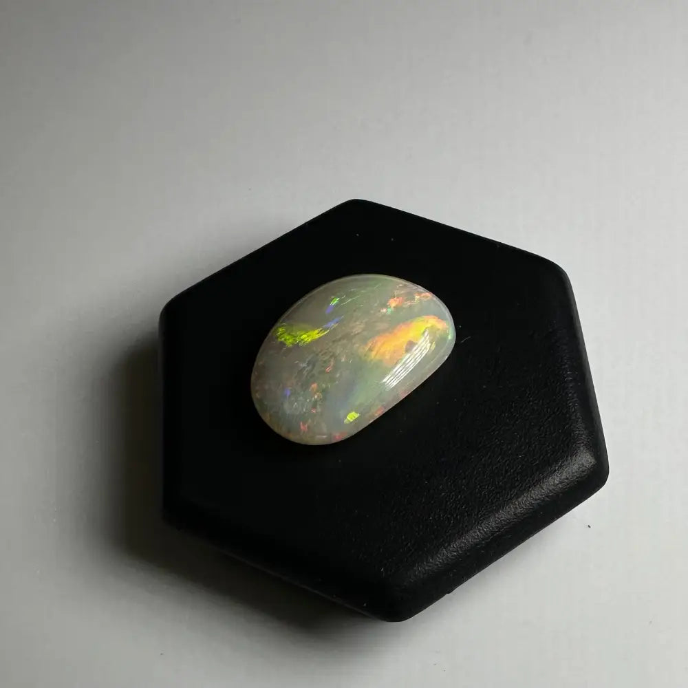 Iridescent opal cabochon from Lightning Ridge showcasing vibrant play of colors